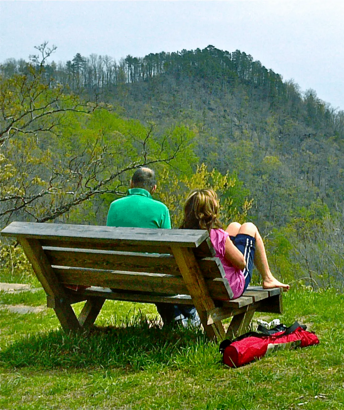 A couple sits on a bench enjoying the view at Point Lookout in Marion, North Carolina