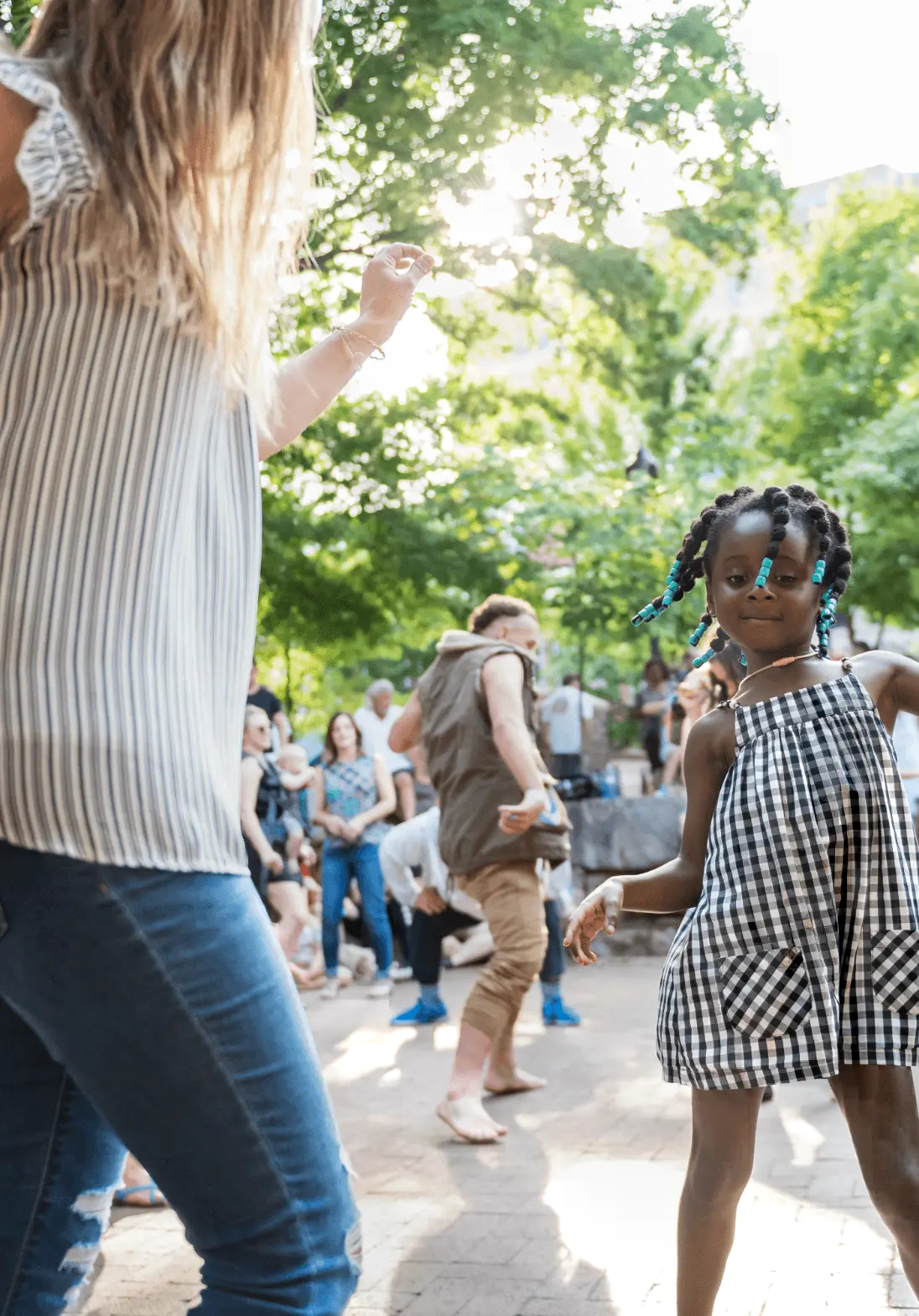 A young girl and a woman dance at a drum circle gathering in Asheville, North Carolina