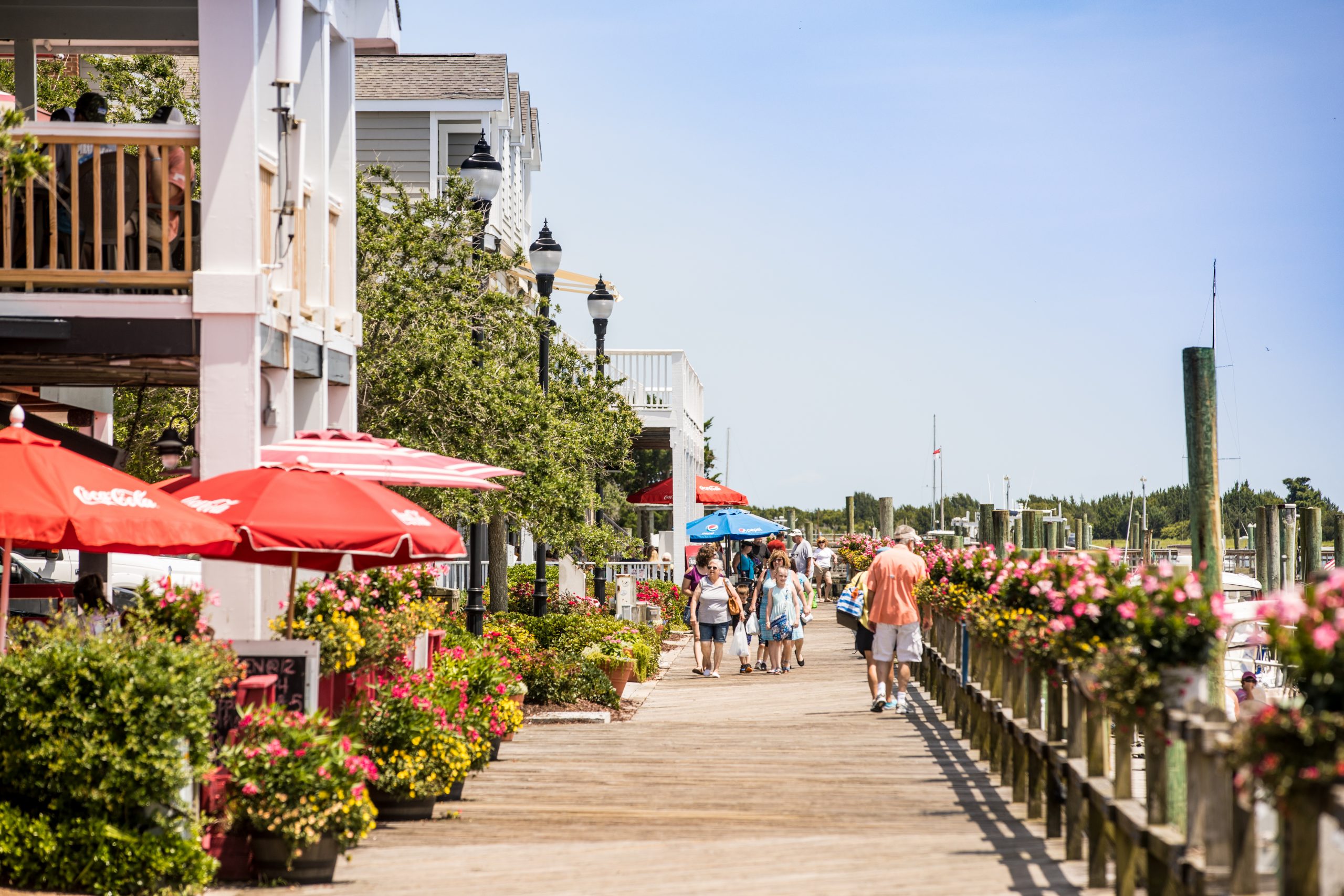 People walking on the boardwalk in the Outer Banks., 