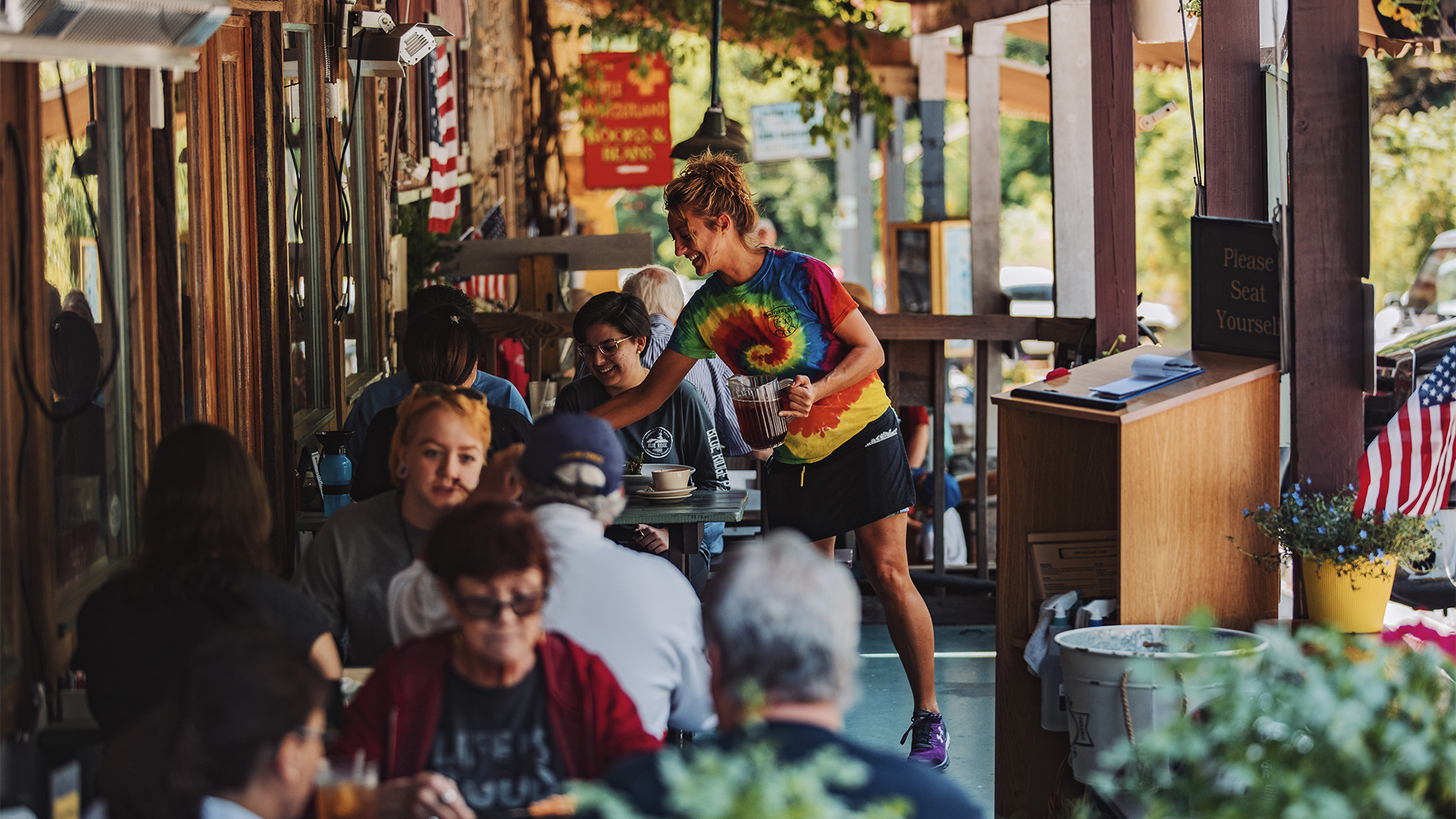 People sitting at patio tables at Switzerland Café in Marion North Carolina